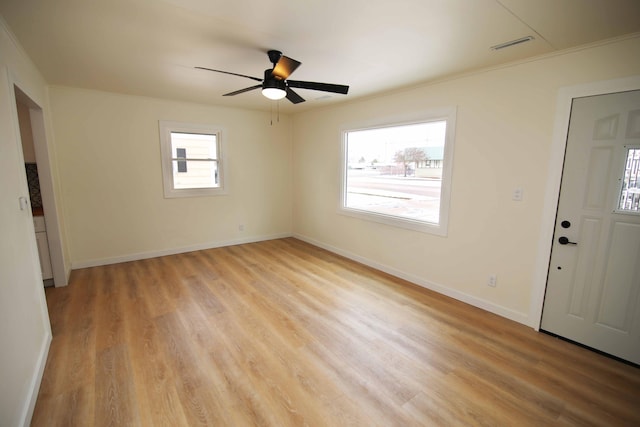 entrance foyer with ceiling fan, a wealth of natural light, and light hardwood / wood-style floors