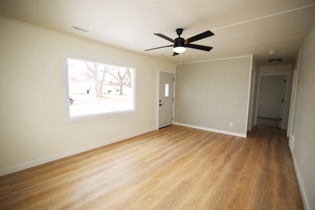 unfurnished room with ceiling fan, crown molding, and light hardwood / wood-style floors