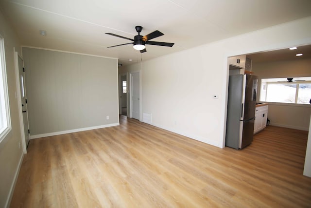 unfurnished room with ceiling fan and light hardwood / wood-style floors