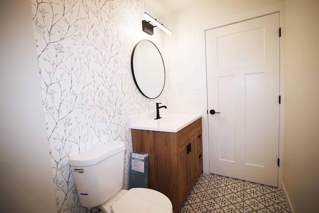 bathroom featuring toilet and vanity