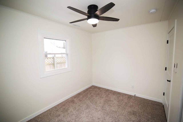 carpeted spare room with ceiling fan