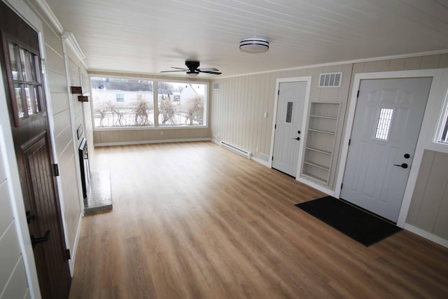 entrance foyer featuring light wood-type flooring, ceiling fan, crown molding, and a baseboard heating unit