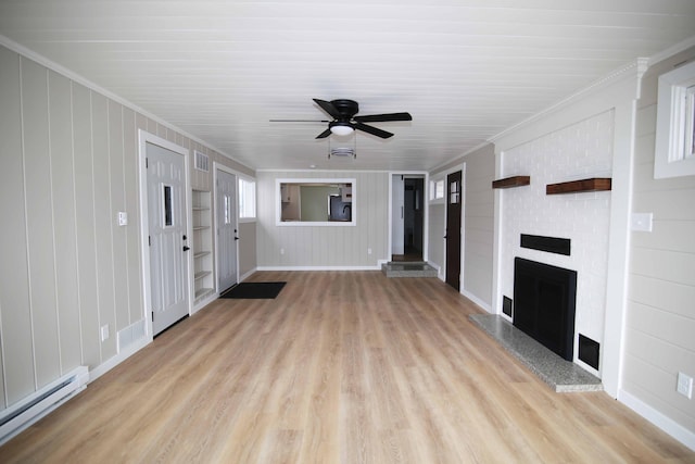 unfurnished living room with a baseboard heating unit, ceiling fan, light wood-type flooring, a fireplace, and crown molding