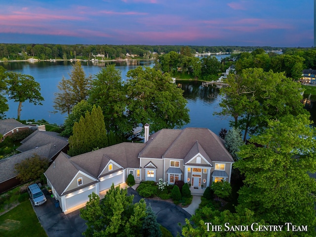 aerial view at dusk with a water view