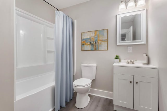 full bathroom with hardwood / wood-style floors, toilet, vanity, and shower / bath combo