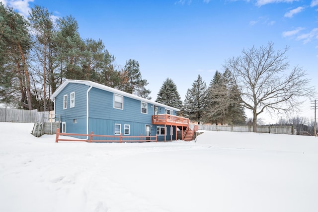 snow covered property with a deck