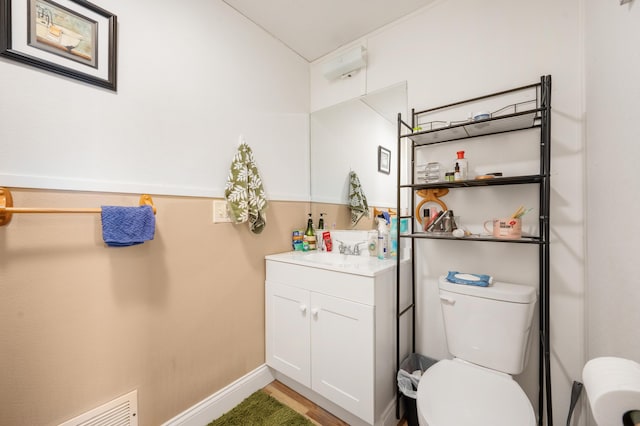 bathroom with vanity, wood-type flooring, and toilet