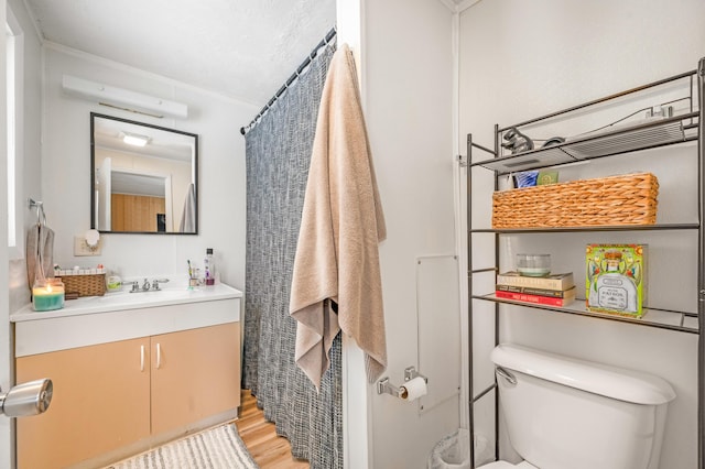 bathroom featuring vanity, hardwood / wood-style floors, a shower with shower curtain, and toilet