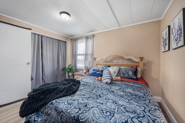 bedroom featuring hardwood / wood-style flooring and ornamental molding