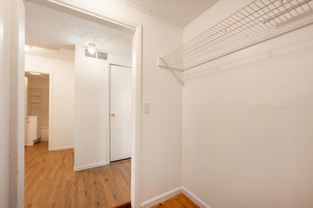 walk in closet featuring wood-type flooring