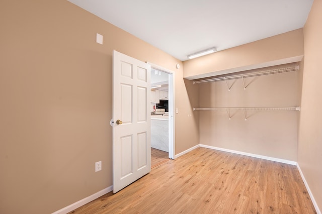 spacious closet featuring light wood-type flooring