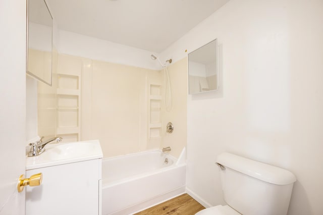 full bathroom featuring vanity, hardwood / wood-style flooring, toilet, and washtub / shower combination