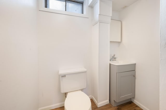 bathroom with vanity, hardwood / wood-style floors, and toilet