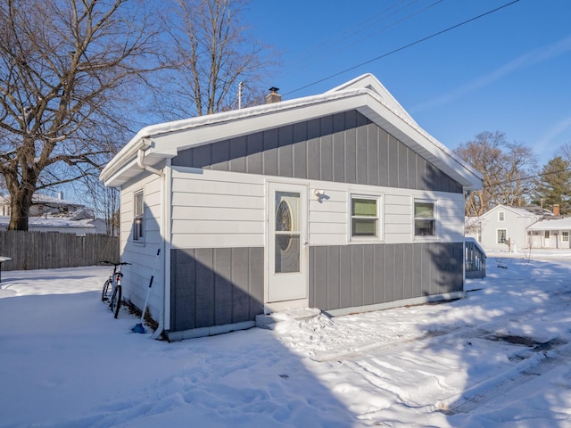 view of snow covered rear of property