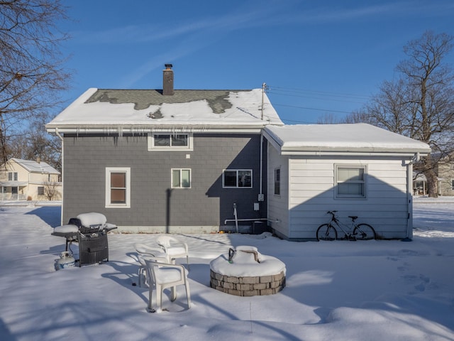 view of snow covered rear of property