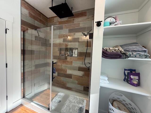 bathroom with a shower with door