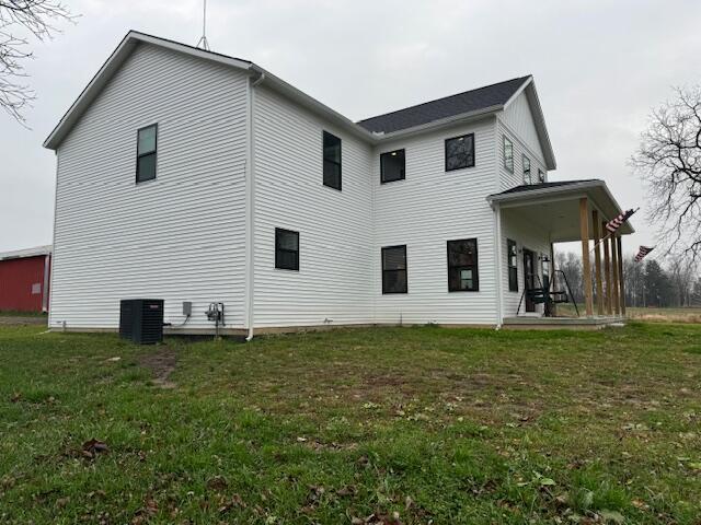 back of house with a patio area, cooling unit, and a lawn