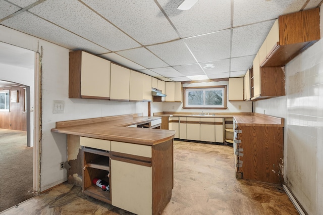 kitchen featuring butcher block countertops, cream cabinets, a paneled ceiling, and kitchen peninsula