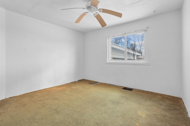 empty room featuring ceiling fan and carpet flooring