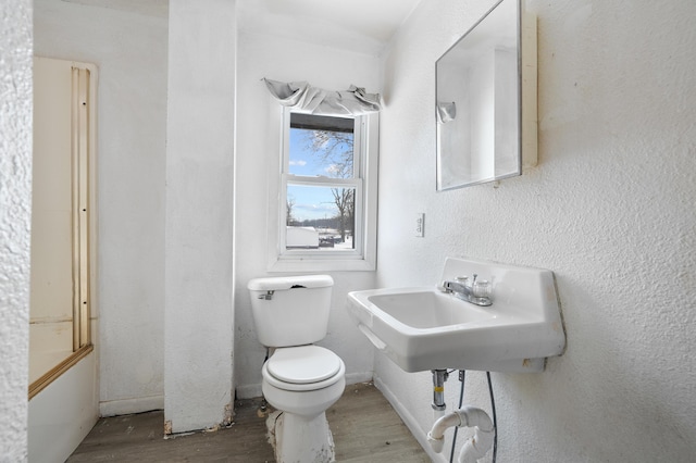 full bathroom with sink, hardwood / wood-style flooring, bathing tub / shower combination, and toilet