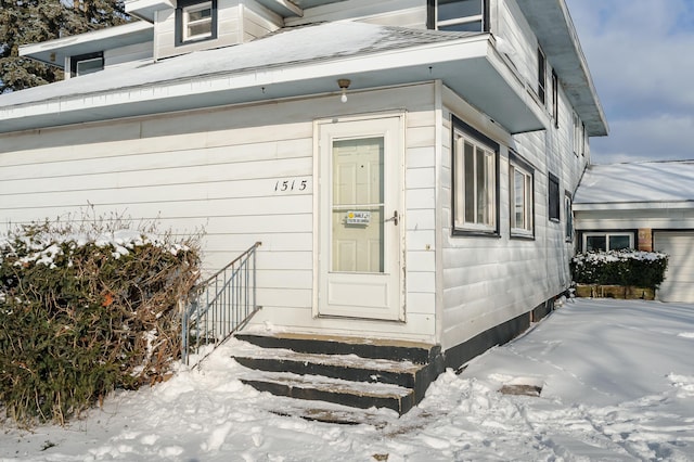 view of snow covered property entrance