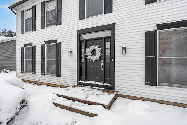 view of snow covered property entrance