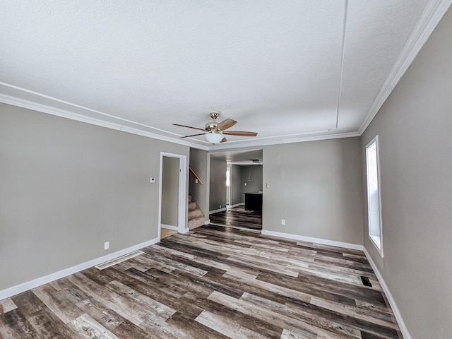 empty room with ceiling fan, wood-type flooring, ornamental molding, and a textured ceiling