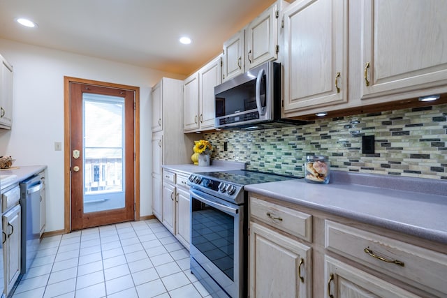 kitchen with backsplash, light tile patterned floors, and stainless steel appliances