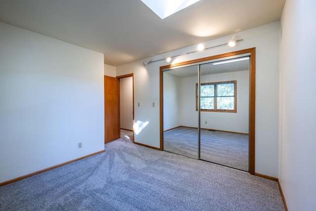 unfurnished bedroom with carpet and a closet