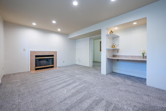 unfurnished living room with light colored carpet and a fireplace