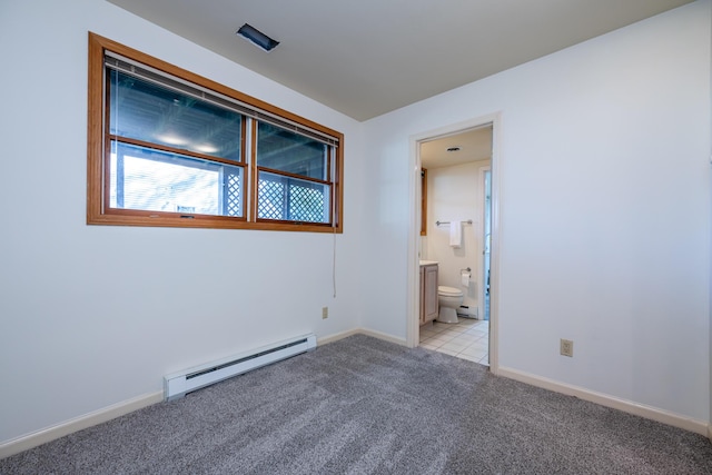 empty room with light colored carpet and baseboard heating