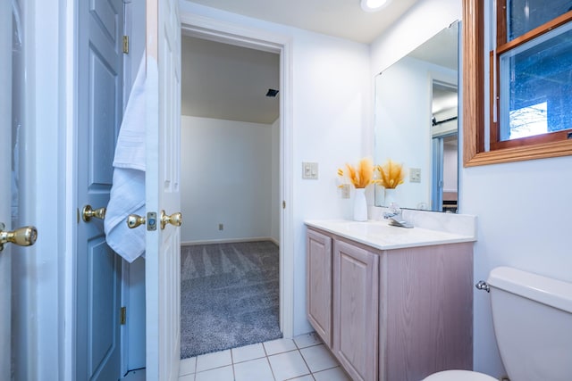 bathroom featuring toilet, tile patterned floors, and vanity