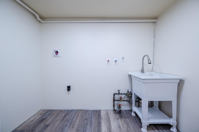 laundry area with hardwood / wood-style floors