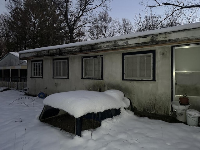 view of snow covered back of property