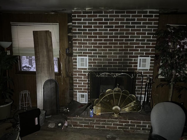 details with wooden walls and a brick fireplace