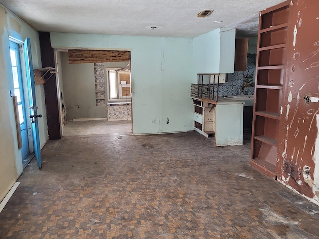 unfurnished living room with a textured ceiling