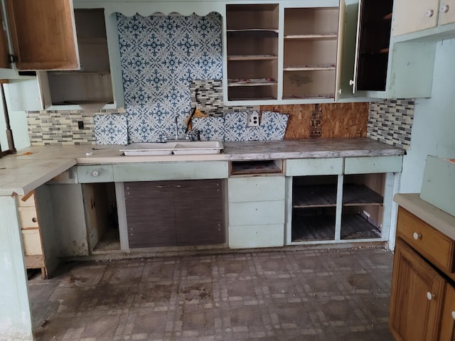 kitchen featuring tasteful backsplash and sink