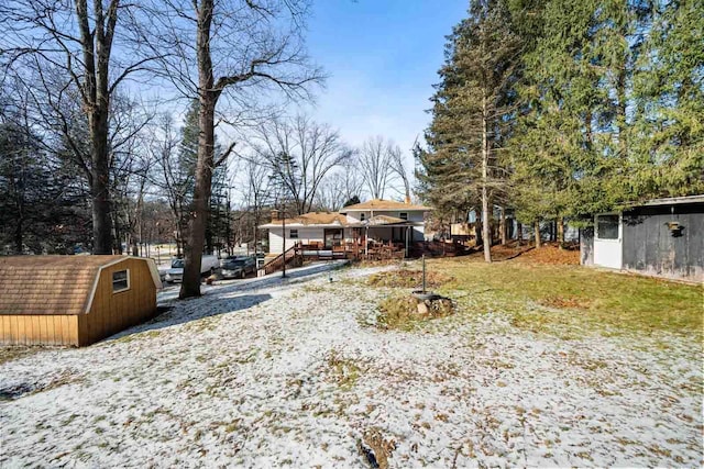 exterior space featuring an outbuilding, a deck, and a storage unit