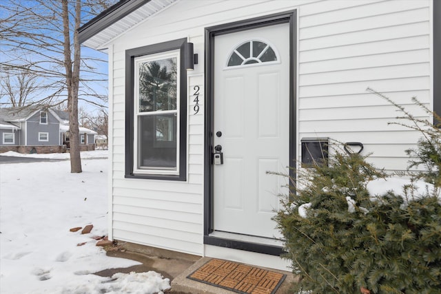 view of snow covered property entrance