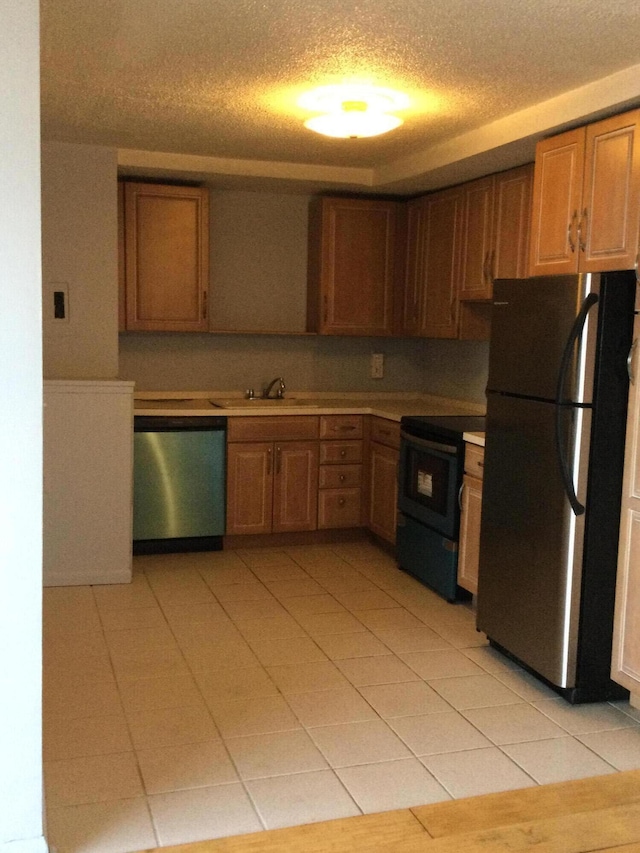 kitchen with sink, light tile patterned floors, and stainless steel appliances