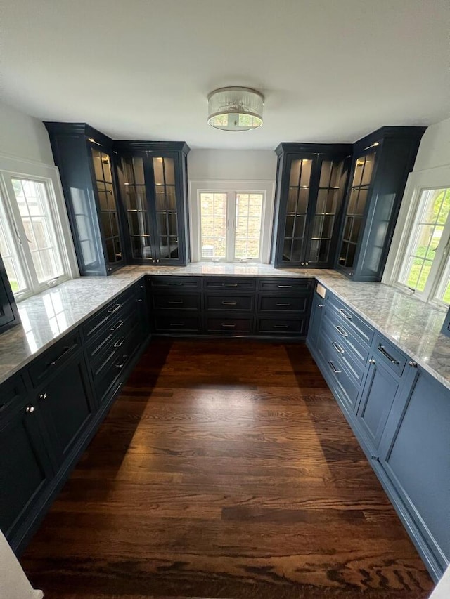 kitchen featuring dark wood-type flooring and light stone counters