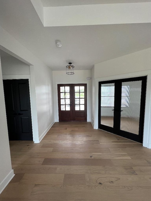 foyer entrance featuring french doors and hardwood / wood-style floors