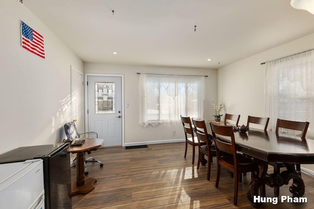 dining room with dark hardwood / wood-style floors