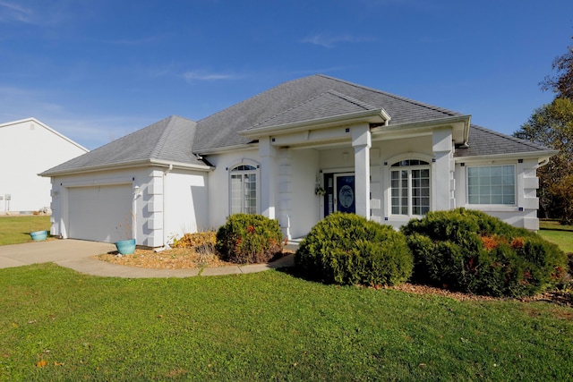 ranch-style house featuring a garage and a front lawn