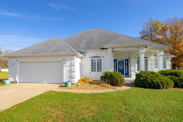 view of front of house featuring a garage and a front lawn