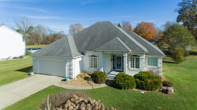 ranch-style house with a garage and a front lawn