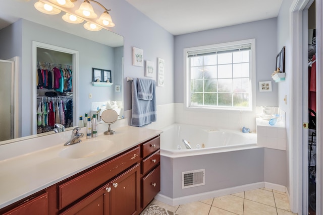 bathroom featuring tile patterned floors, vanity, and a bathing tub