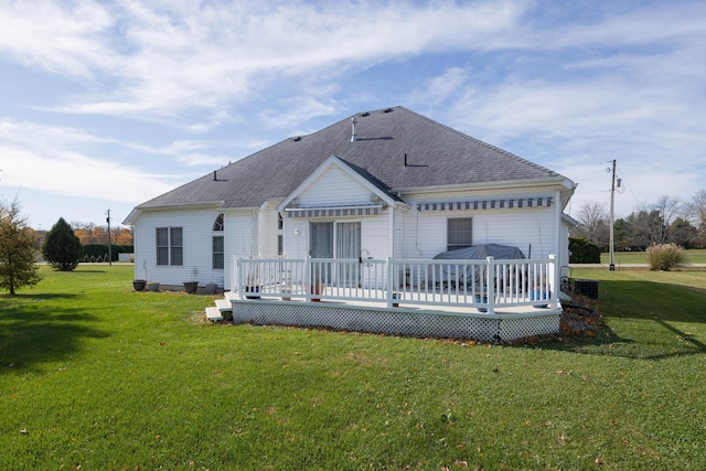 back of property with a wooden deck and a yard