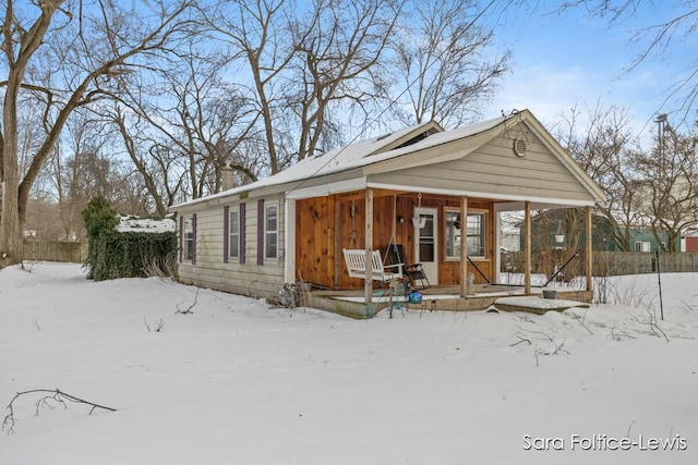 snow covered house with a porch