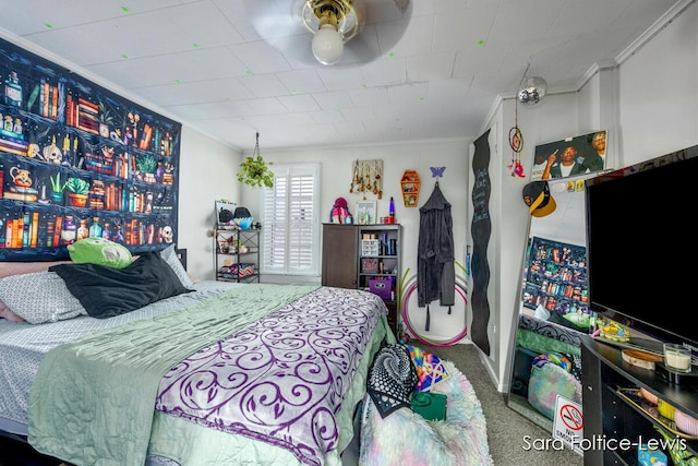 bedroom with carpet floors and crown molding